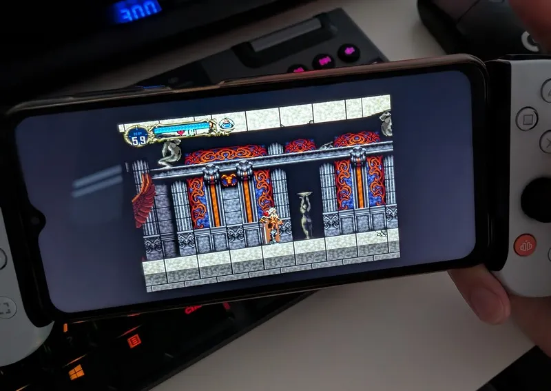 Castlevania Symphony of the Night on a Samsung A23 phone. The screen shows a vampire hunter standing inside a gothic castle in a pixelated style.